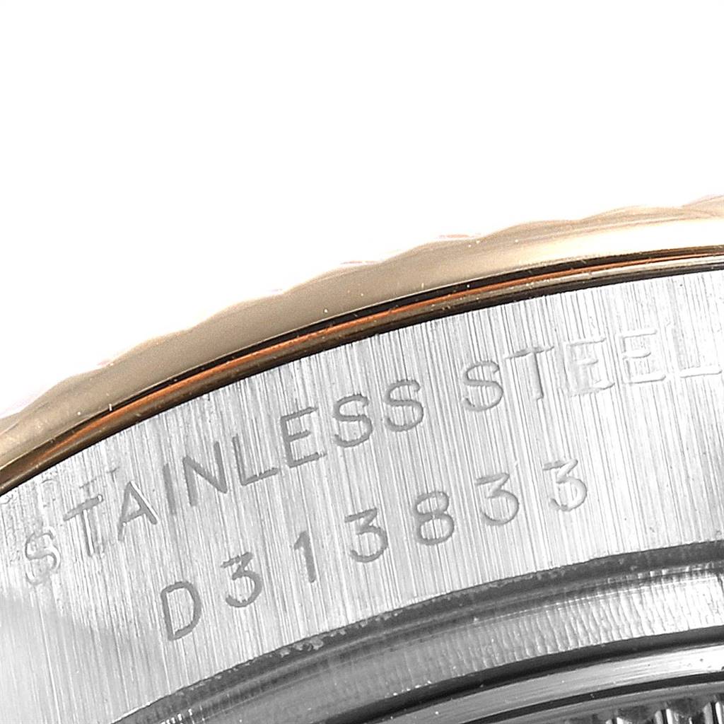 The image shows a close-up of the side of a Rolex Datejust 179173 Women's Steel and Gold (two tone) Mother of Pearl Dial 179173 Women's Steel and Gold (two tone) Mother of Pearl Dial watch, highlighting the stainless steel part and serial number.