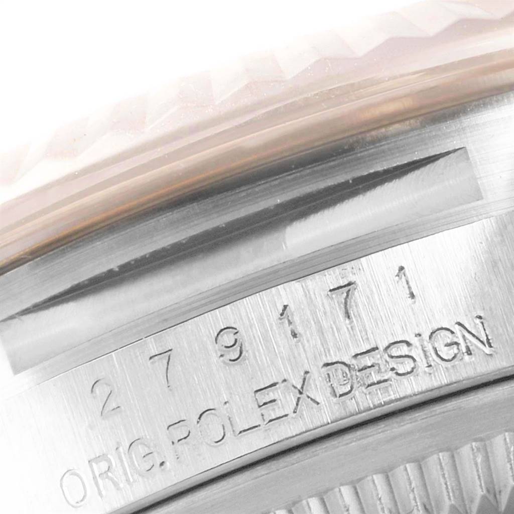 This close-up image shows the serial number and "ORIG. ROLEX DESIGN" engraved on the case of a Rolex Datejust 279171 Women's Steel and Gold (two tone) Mother of Pearl Dial 279171 Women's Steel and Gold (two tone) Mother of Pearl Dial watch.