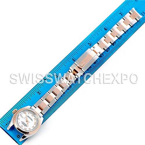 The image shows the Rolex Datejust 179161 Women's Steel and Gold (two tone) White Dial 179161 Women's Steel and Gold (two tone) White Dial watch laid flat with its strap fully extended next to a blue ruler for measurement.