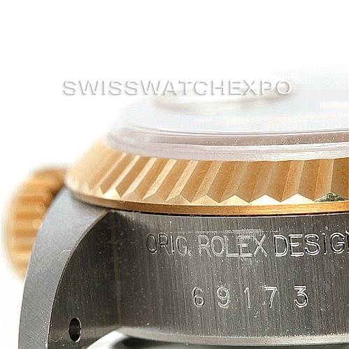 The image shows a close-up of the side of a Rolex Datejust 69173 Women's Stainless Steel Beige Dial 69173 Women's Stainless Steel Beige Dial watch, featuring part of the bezel, the crown, and the engraved model number 69173.