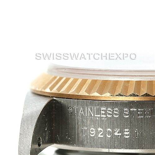 The image shows a close-up of the side of a Rolex Datejust 69173 Women's Stainless Steel Beige Dial 69173 Women's Stainless Steel Beige Dial watch, focusing on its bezel and part of the case with engraving.