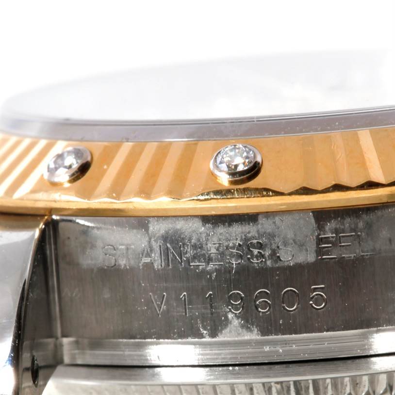 Close-up of the Rolex Datejust 179313 Women's Stainless Steel Beige Dial 179313 Women's Stainless Steel Beige Dial watch showing the side of the case, bezel with diamonds, and the serial number.