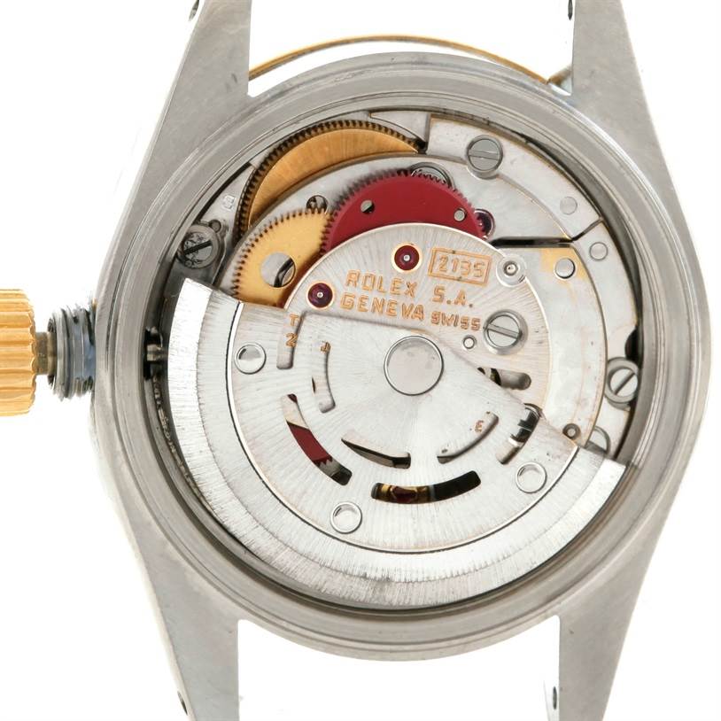 The image shows the back view of a Rolex Datejust 69173 Women's Stainless Steel Beige Dial 69173 Women's Stainless Steel Beige Dial watch, highlighting its intricate internal movement and gears.