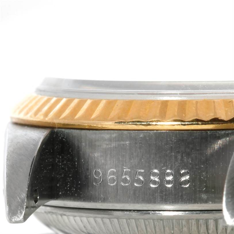 This image shows a close-up angle of a Rolex Datejust 69173 Women's Stainless Steel Beige Dial 69173 Women's Stainless Steel Beige Dial watch, focusing on its case, bezel, and serial number.