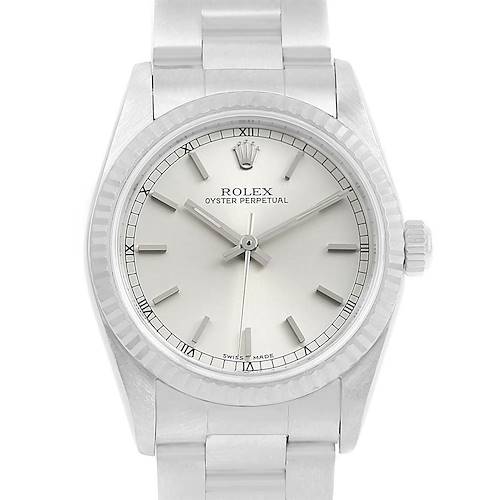 The Rolex Mid-Size 77014 Women's Stainless Steel Silver Dial 77014 Women's Stainless Steel Silver Dial Oyster Perpetual watch is shown from the front, displaying the dial, hands, bezel, and part of the bracelet.