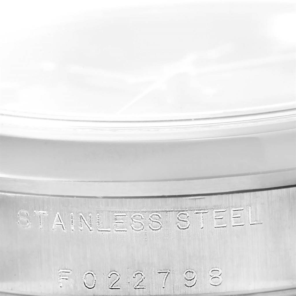 This image shows a close-up of the serial number and "Stainless Steel" engraving on a Rolex Mid-Size 78240 Women's Stainless Steel Black Dial 78240 Women's Stainless Steel Black Dial model watch case.