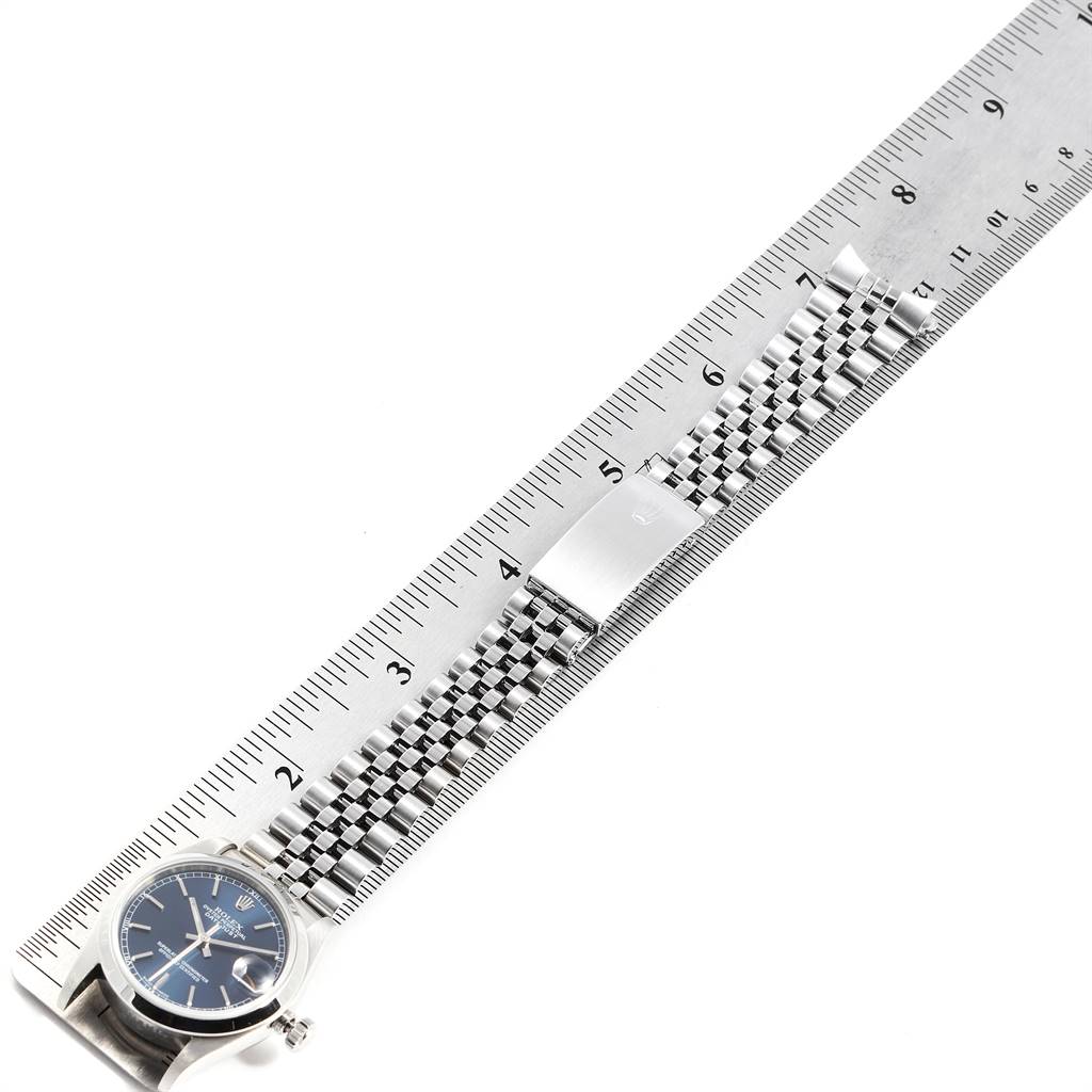 The Rolex Mid-Size 78240 Women's Stainless Steel Blue Dial 78240 Women's Stainless Steel Blue Dial watch is shown lying flat, with its face and bracelet aligned alongside a ruler for measurement.