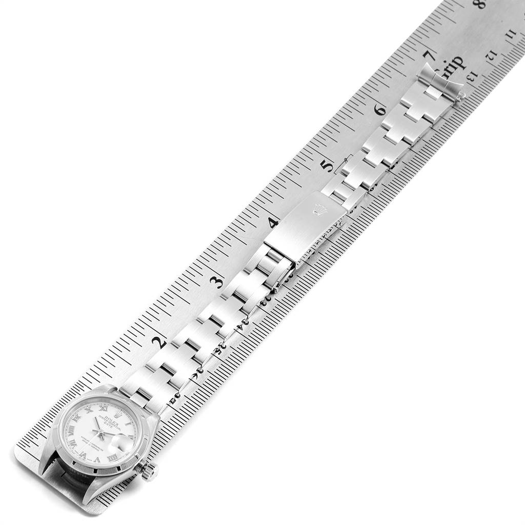 The Rolex Date 79190 Women's Stainless Steel White Dial 79190 Women's Stainless Steel White Dial watch is shown flat, with its face, bracelet, and clasp beside a ruler for size reference.