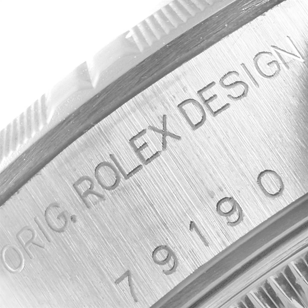 This close-up shows the case side and engraving of the Date model watch by Rolex.