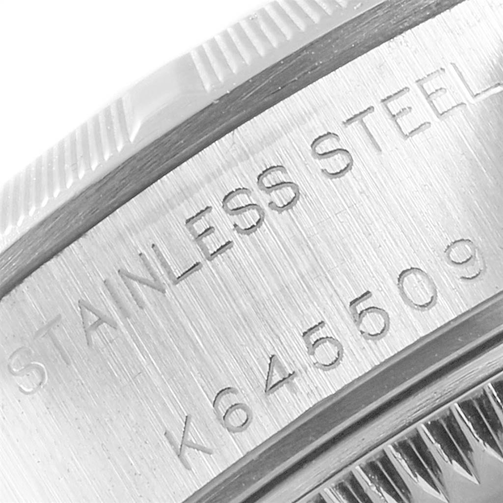 This is a close-up image of the case back of a Rolex Date 79190 Women's Stainless Steel White Dial 79190 Women's Stainless Steel White Dial model, showing the serial number and "STAINLESS STEEL" engraving.