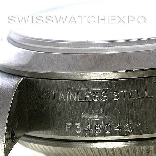 This close-up image shows the side of a Rolex Date 79160 Women's Stainless Steel White Dial 79160 Women's Stainless Steel White Dial model watch case, displaying the "STAINLESS STEEL" engraving and serial number.