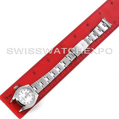 The image shows a Rolex Date 79160 Women's Stainless Steel White Dial 79160 Women's Stainless Steel White Dial model watch laid flat next to a red ruler, highlighting the watch face and metal bracelet.