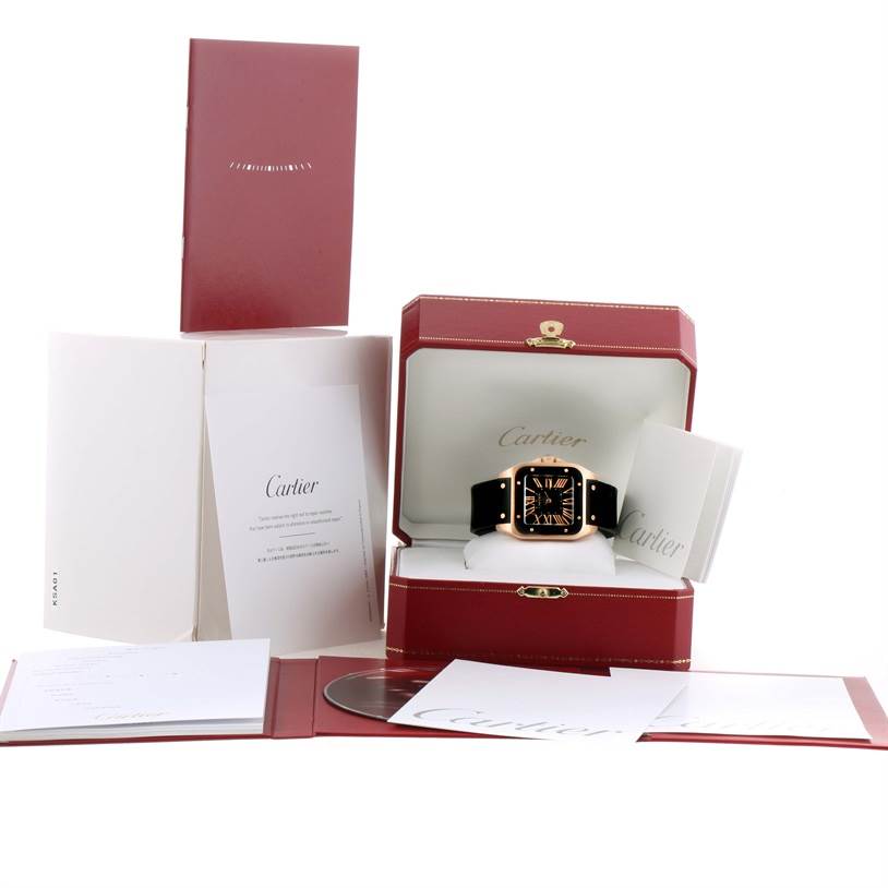 The image shows a Cartier Santos W20124U2 Men's Rose Gold Black Dial W20124U2 Men's Rose Gold Black Dial watch in its presentation box, with booklets and documentation displayed around it.