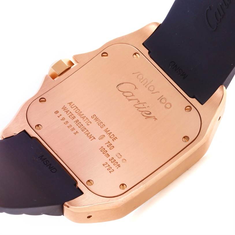 The image shows the case back of a Cartier Santos W20124U2 Men's Rose Gold Black Dial W20124U2 Men's Rose Gold Black Dial watch, highlighting its engravings and adjacent strap parts.