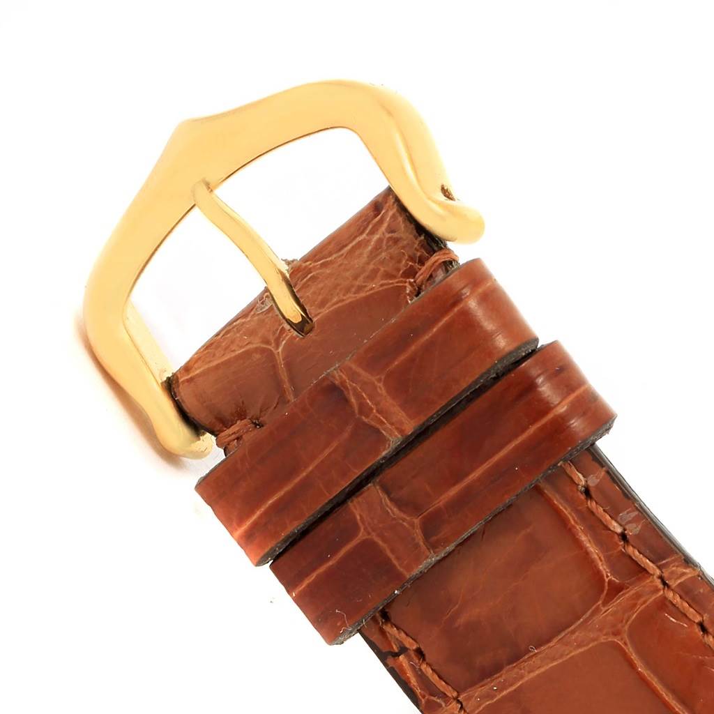 The image shows a close-up of the leather strap and gold buckle of a Cartier Tank Louis W1529756 Men's Yellow Gold Silver Dial W1529756 Men's Yellow Gold Silver Dial watch.