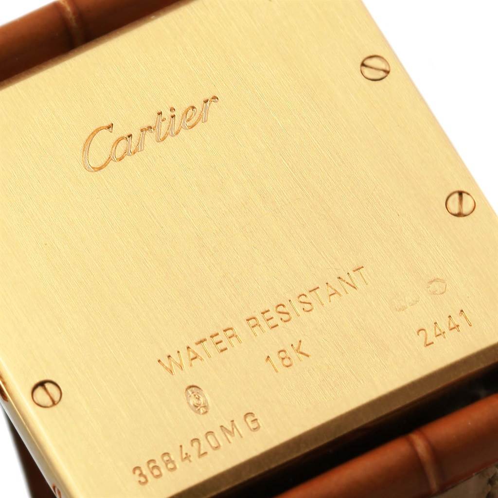 This image shows the back case of a Cartier Tank Louis W1529756 Men's Yellow Gold Silver Dial W1529756 Men's Yellow Gold Silver Dial watch with inscriptions and screw details.