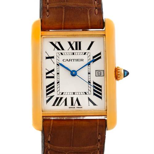 The Tank Louis Cartier watch is shown from a top-down angle, displaying the dial, crown, and upper part of the strap.