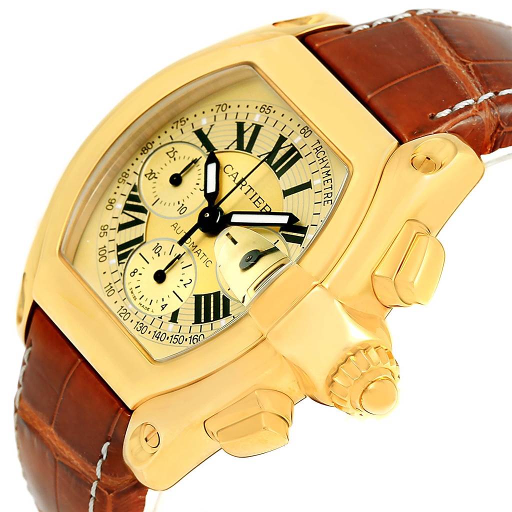 This image shows a close-up, side-angle view of the Cartier Roadster W62021Y3 Men's Yellow Gold Champagne Dial W62021Y3 Men's Yellow Gold Champagne Dial watch, highlighting its dial, crown, and brown leather strap.