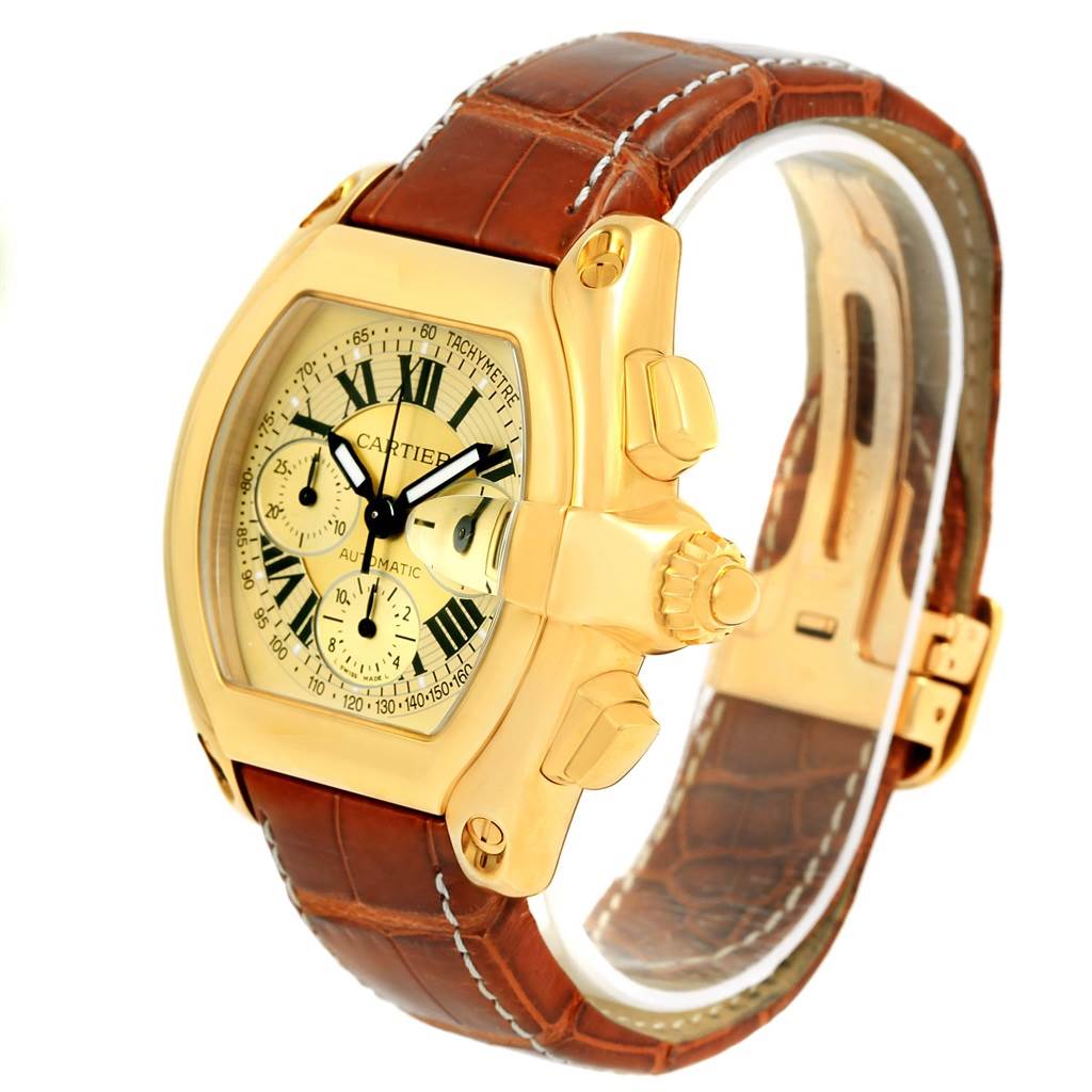 The Cartier Roadster W62021Y3 Men's Yellow Gold Champagne Dial W62021Y3 Men's Yellow Gold Champagne Dial watch is shown at a slight angle, highlighting its face, crown, and brown leather strap.