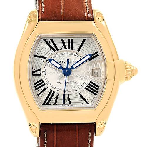 The Cartier Roadster W62005V2 Men's Yellow Gold Silver Dial W62005V2 Men's Yellow Gold Silver Dial watch is shown from a front angle, displaying its gold case, brown leather strap, and Roman numeral dial.