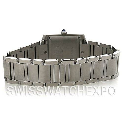 The image shows the back view of a Cartier Tank Francaise W51002Q3 Men's Stainless Steel Silver Dial W51002Q3 Men's Stainless Steel Silver Dial watch, highlighting the bracelet, case back, and crown with a blue cabochon.