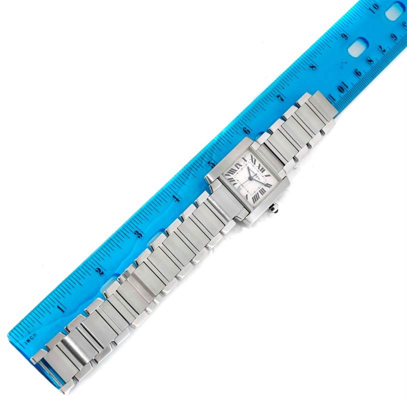 The Cartier Tank Francaise W51002Q3 Men's Stainless Steel Silver Dial W51002Q3 Men's Stainless Steel Silver Dial watch is shown from a top-down angle, lying flat beside a blue ruler for scale.