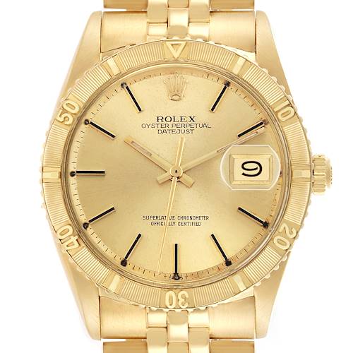 The Rolex Turn-o-Graph 1625 Men's Yellow Gold Champagne Dial 1625 Men's Yellow Gold Champagne Dial watch is shown from a front angle, displaying its dial, bezel with numerals, and partial bracelet.