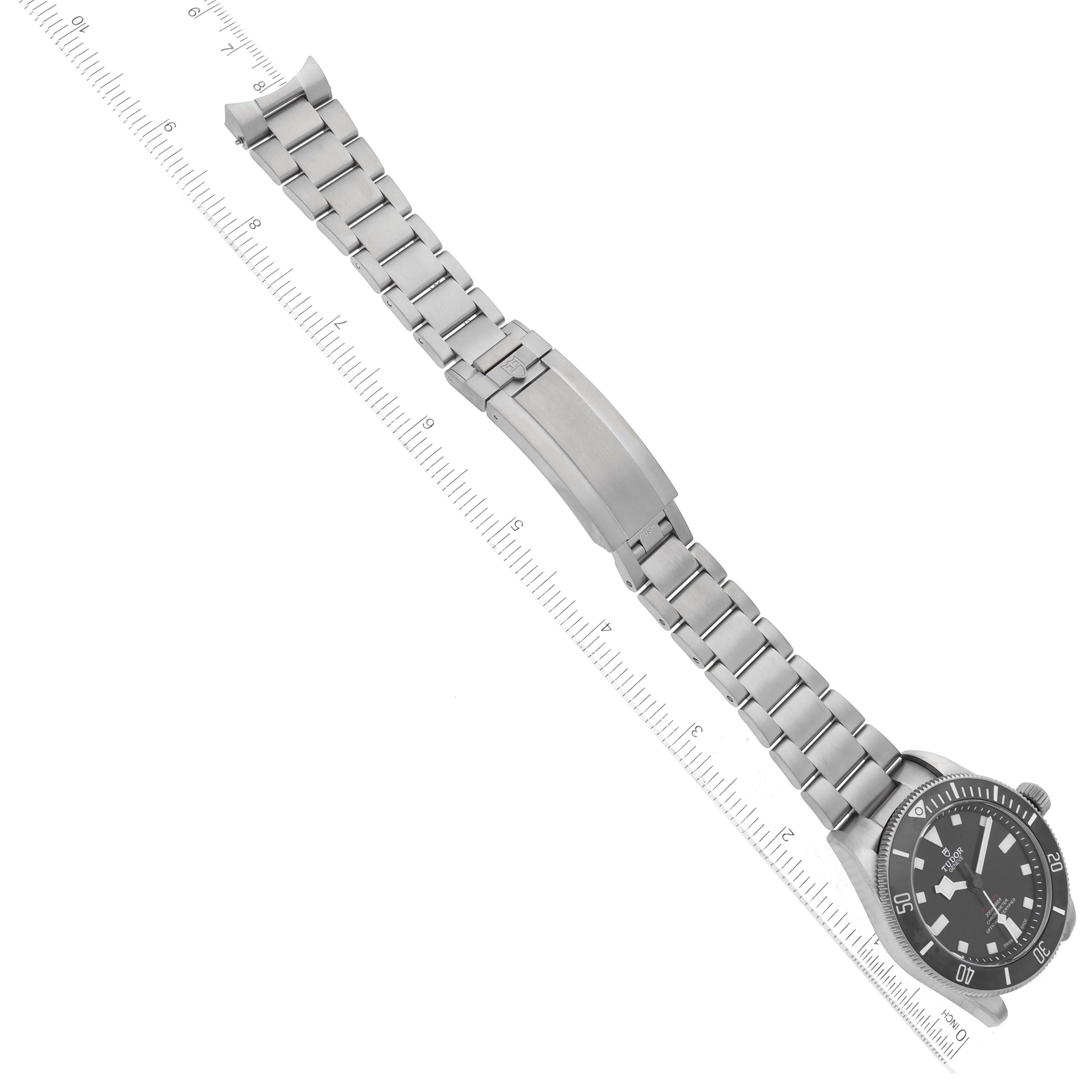 The image shows the Tudor Pelagos 25407N Men's Titanium Black Dial 25407N Men's Titanium Black Dial watch displayed diagonally, including the watch face, bracelet, and clasp, alongside a ruler for scale.