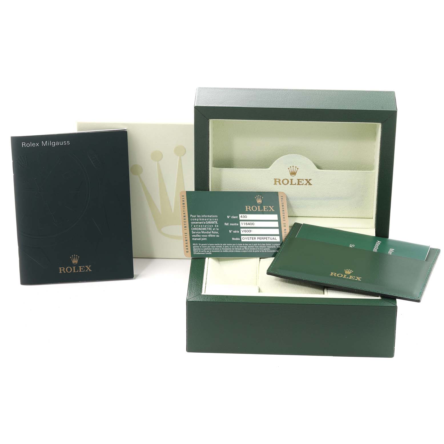 The image shows the packaging and accessories of the Rolex Milgauss 116400 Men's Stainless Steel White Dial 116400 Men's Stainless Steel White Dial watch, including the box, manuals, and warranty card.