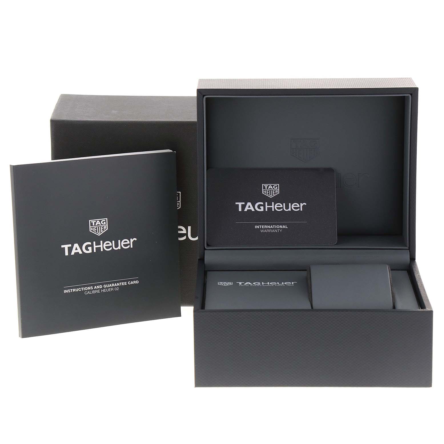 The image shows the packaging, instruction booklet, and warranty card for the Tag Heuer Carrera CBN2A10.BA0643 Men's Stainless Steel Green Dial CBN2A10.BA0643 Men's Stainless Steel Green Dial model.