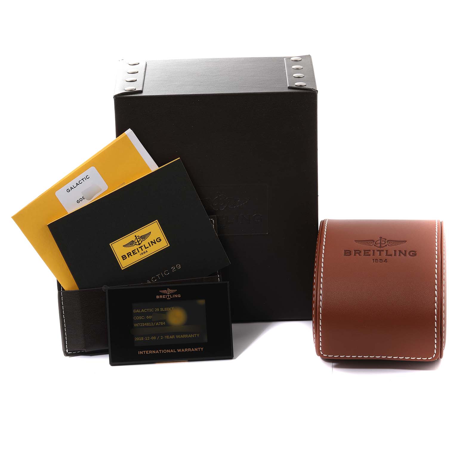 The image shows the packaging and accessories of the Breitling W7234812/A784 Women's Stainless Steel Mother of Pearl Dial W7234812/A784 Women's Stainless Steel Mother of Pearl Dial Galactic 29 Ladies Watch, including boxes, booklets, and a warranty card.