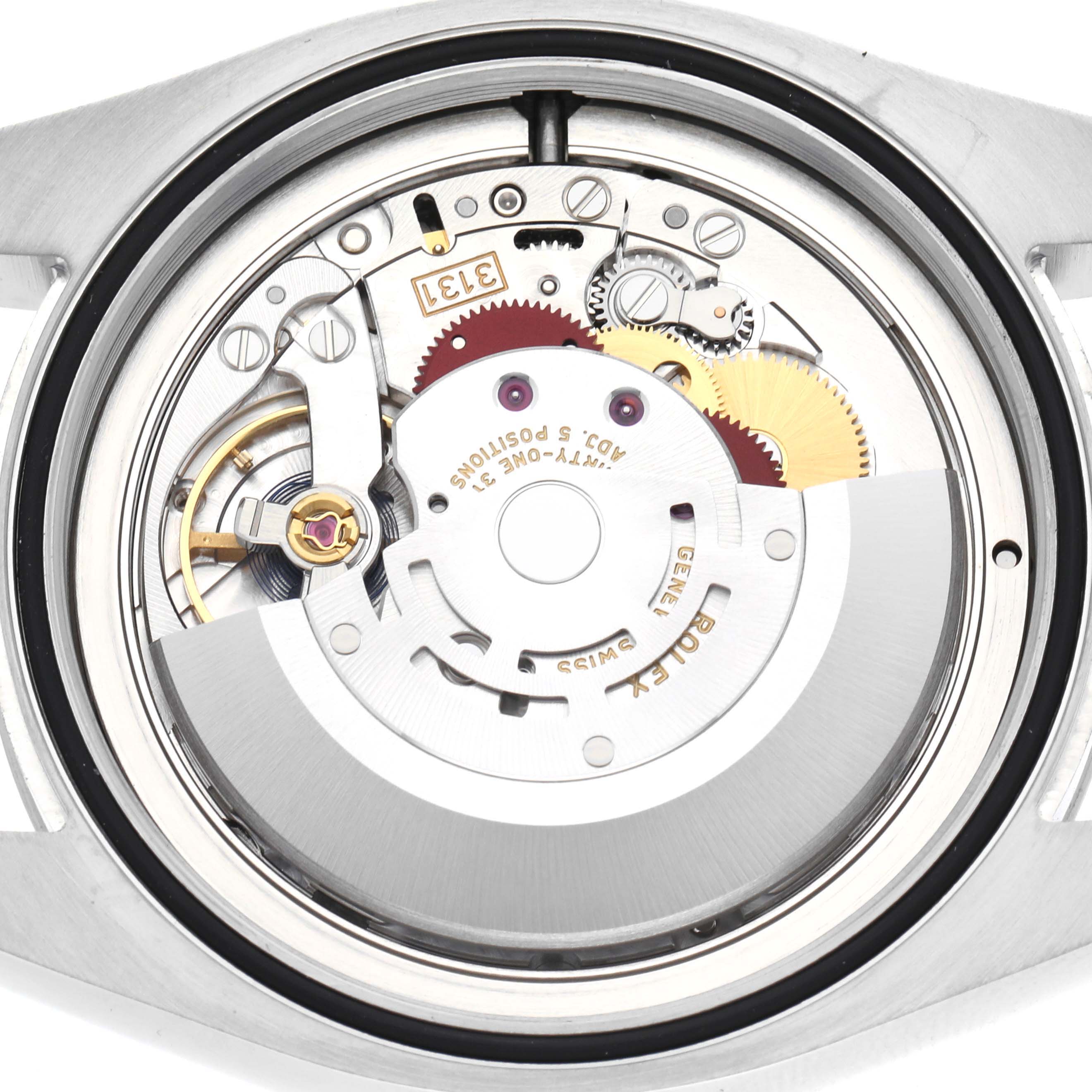 The image shows the movement of a Rolex Air-King 116900 Men's Stainless Steel Black Dial 116900 Men's Stainless Steel Black Dial watch, viewed from the back, highlighting gears and mechanical components.