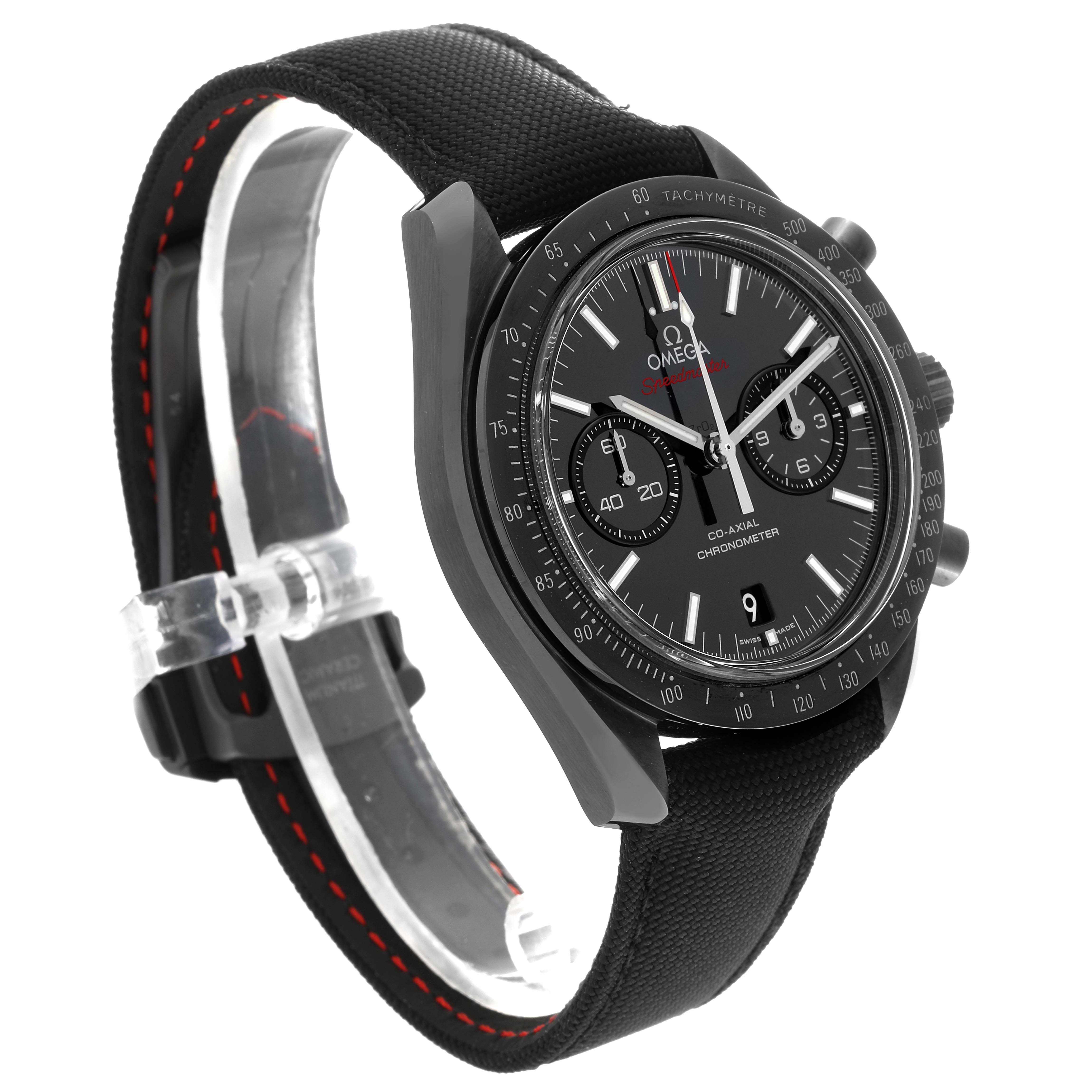The image shows an angled view of an Omega Speedmaster 311.92.44.51.01.007 Men's Ceramic Black Dial 311.92.44.51.01.007 Men's Ceramic Black Dial watch, displaying its face, bezel, and fabric strap with red stitching.