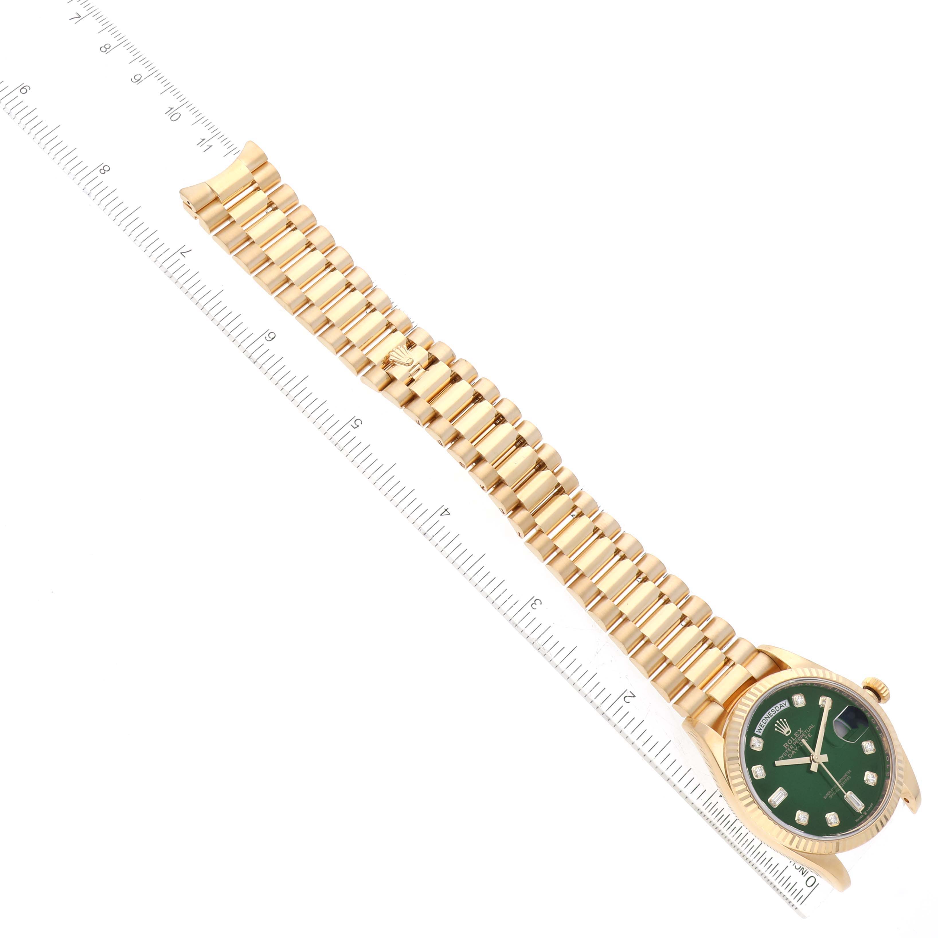 This image shows a Rolex President 128238 Men's Yellow Gold Green Dial 128238 Men's Yellow Gold Green Dial model watch at an oblique angle, with the band and dial alongside a measurement ruler.