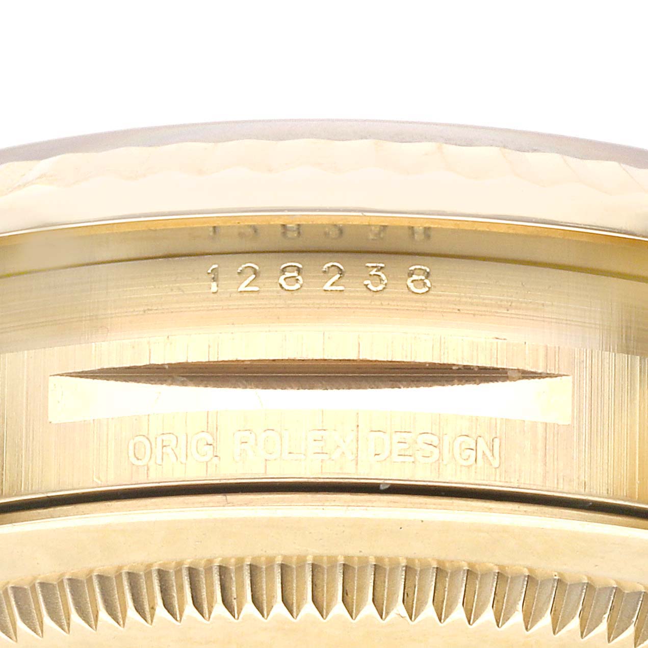 This image shows the side view of the case of a Rolex President 128238 Men's Yellow Gold Green Dial 128238 Men's Yellow Gold Green Dial model watch, displaying the serial number and "ORIG. ROLEX DESIGN" engraving.
