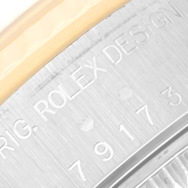 This close-up image shows the engraved serial number and branding on the back of a Rolex Datejust 79173 Women's Steel and Gold (two tone) Beige Dial 79173 Women's Steel and Gold (two tone) Beige Dial watch.