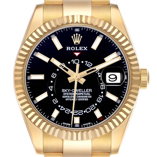 The Rolex Sky-Dweller 326938 Men's Yellow Gold Black Dial 326938 Men's Yellow Gold Black Dial watch is shown from a front angle, highlighting the black dial, gold markers, date window, and fluted bezel.