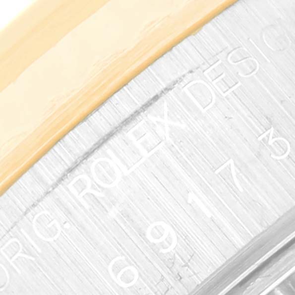 This close-up of the Rolex Datejust 69173 Women's Steel and Gold (two tone) Grey Dial 69173 Women's Steel and Gold (two tone) Grey Dial watch shows the outer edge of the bezel and the engraved text on the case.