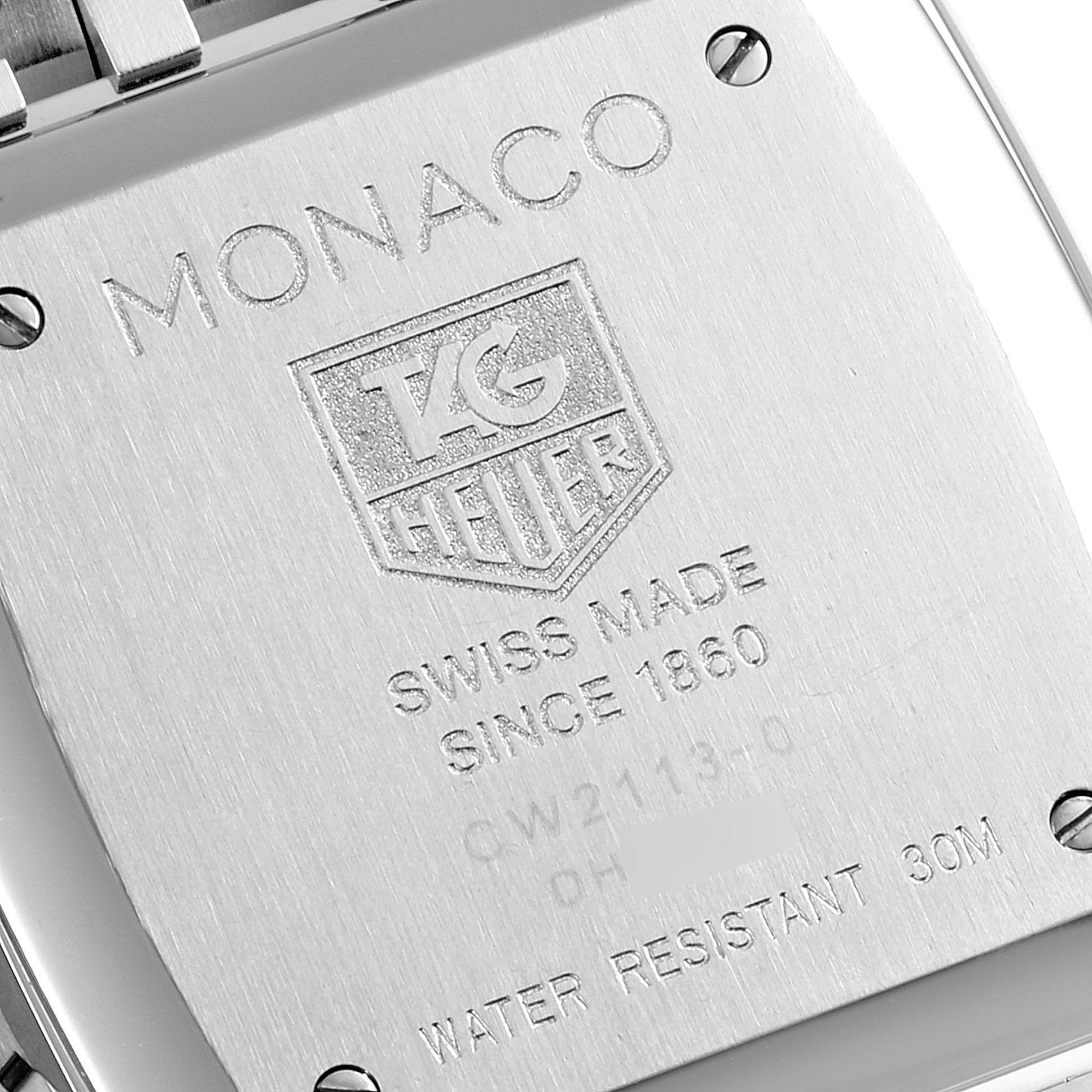 The image shows the back case of a Tag Heuer Monaco CW2113.BA0780 Men's Stainless Steel Blue Dial CW2113.BA0780 Men's Stainless Steel Blue Dial watch, highlighting engravings detailing its specifications.