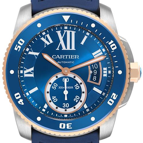 The Calibre de Cartier watch is shown from the front, highlighting the blue dial, bezel, and strap.