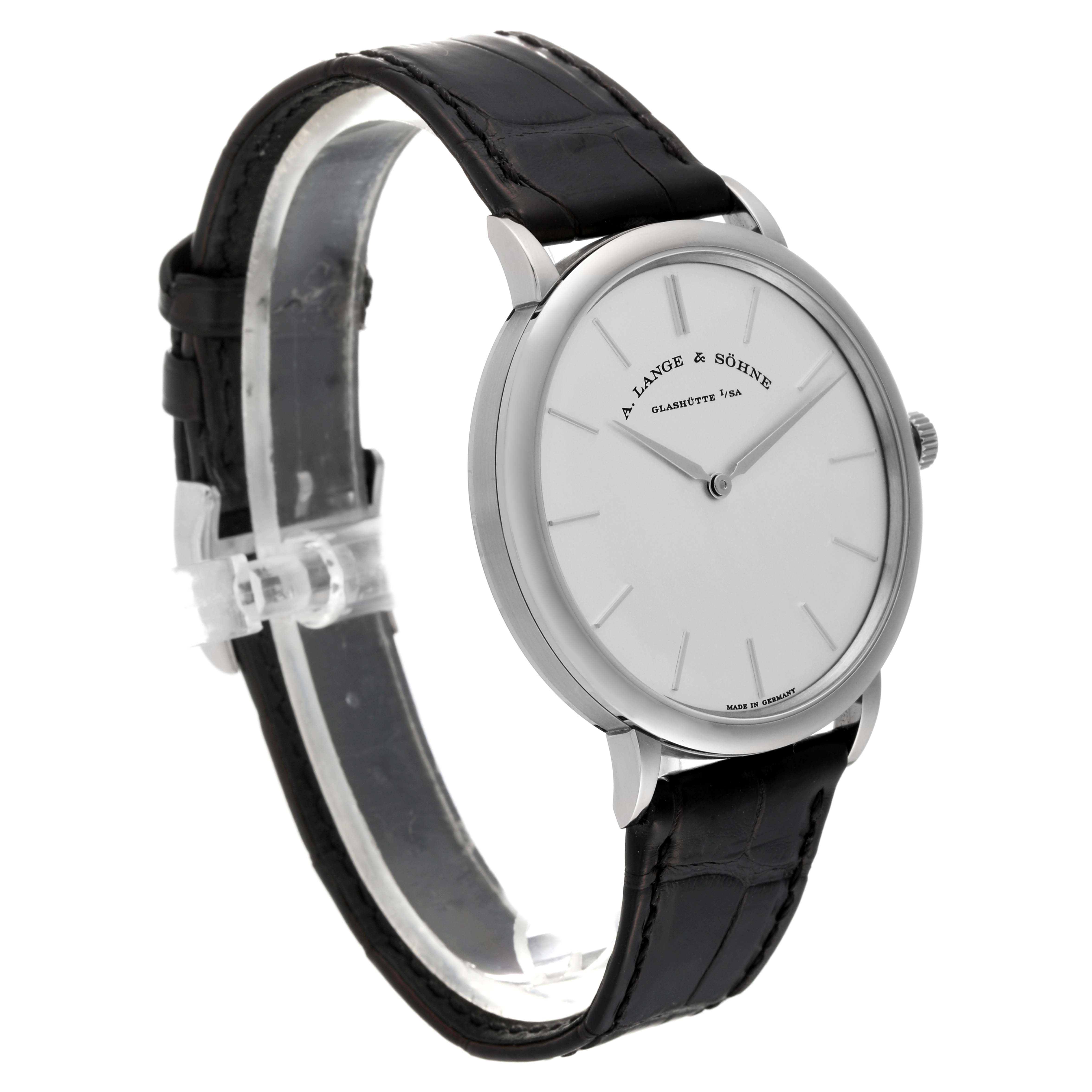 The A. Lange & Sohne Saxonia 211.027 Men's White Gold Silver Dial watch is shown in a side angle featuring its face, case, and black leather strap.