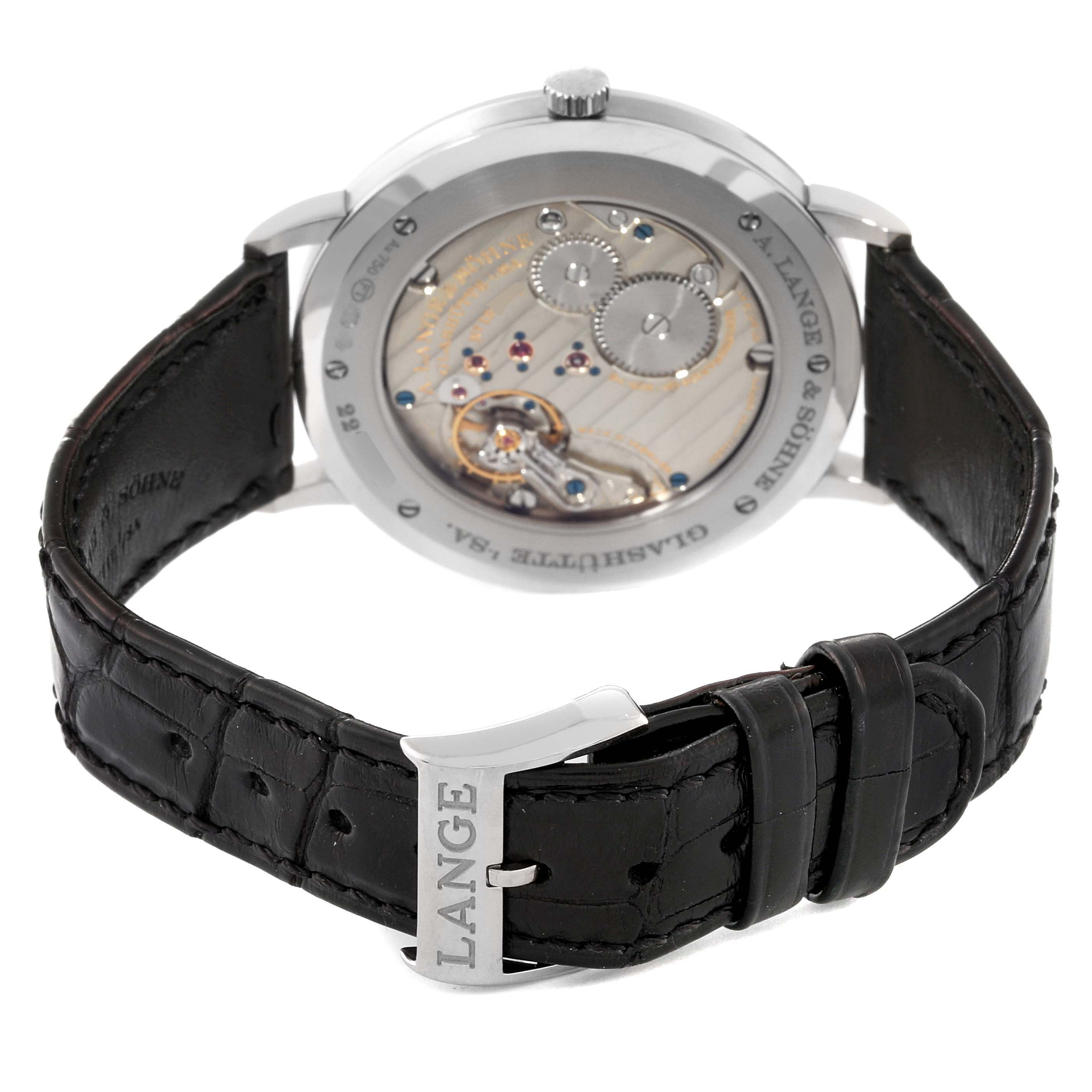 The image shows the Saxonia model by A. Lange & Sohne from the back, highlighting the movement and the leather strap with "LANGE" on the buckle.
