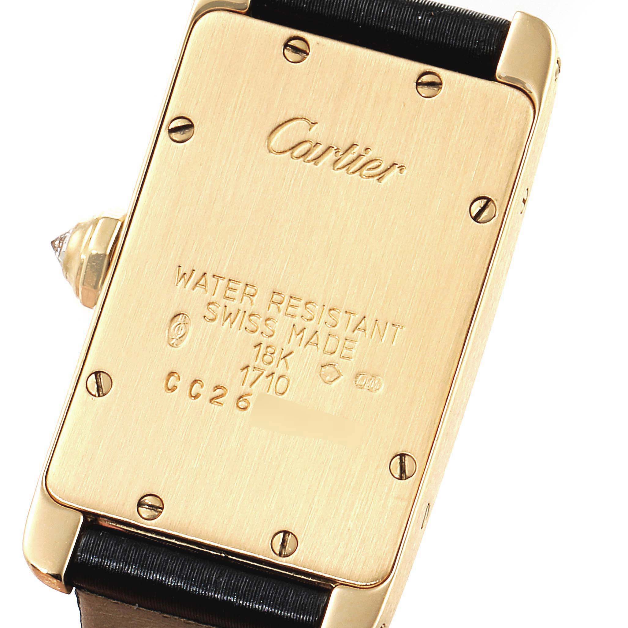 The image shows the backside of the Cartier Tank Americaine 1710 Women's Yellow Gold Silver Dial 1710 Women's Yellow Gold Silver Dial watch, highlighting its case details and markings.