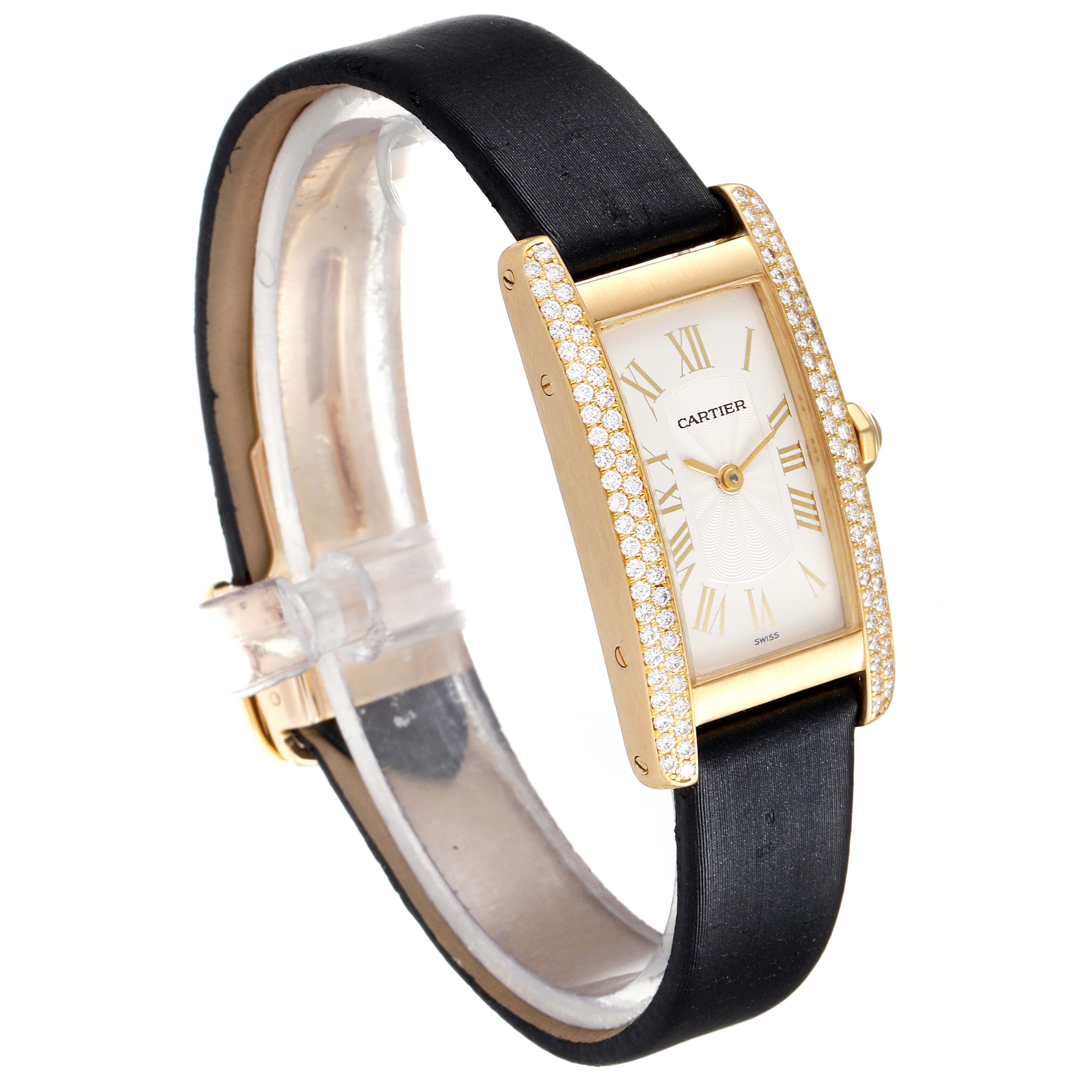 The image shows a Cartier Tank Americaine 1710 Women's Yellow Gold Silver Dial 1710 Women's Yellow Gold Silver Dial watch at a slight side angle, displaying its rectangular face, diamond bezel, gold casing, and black strap.