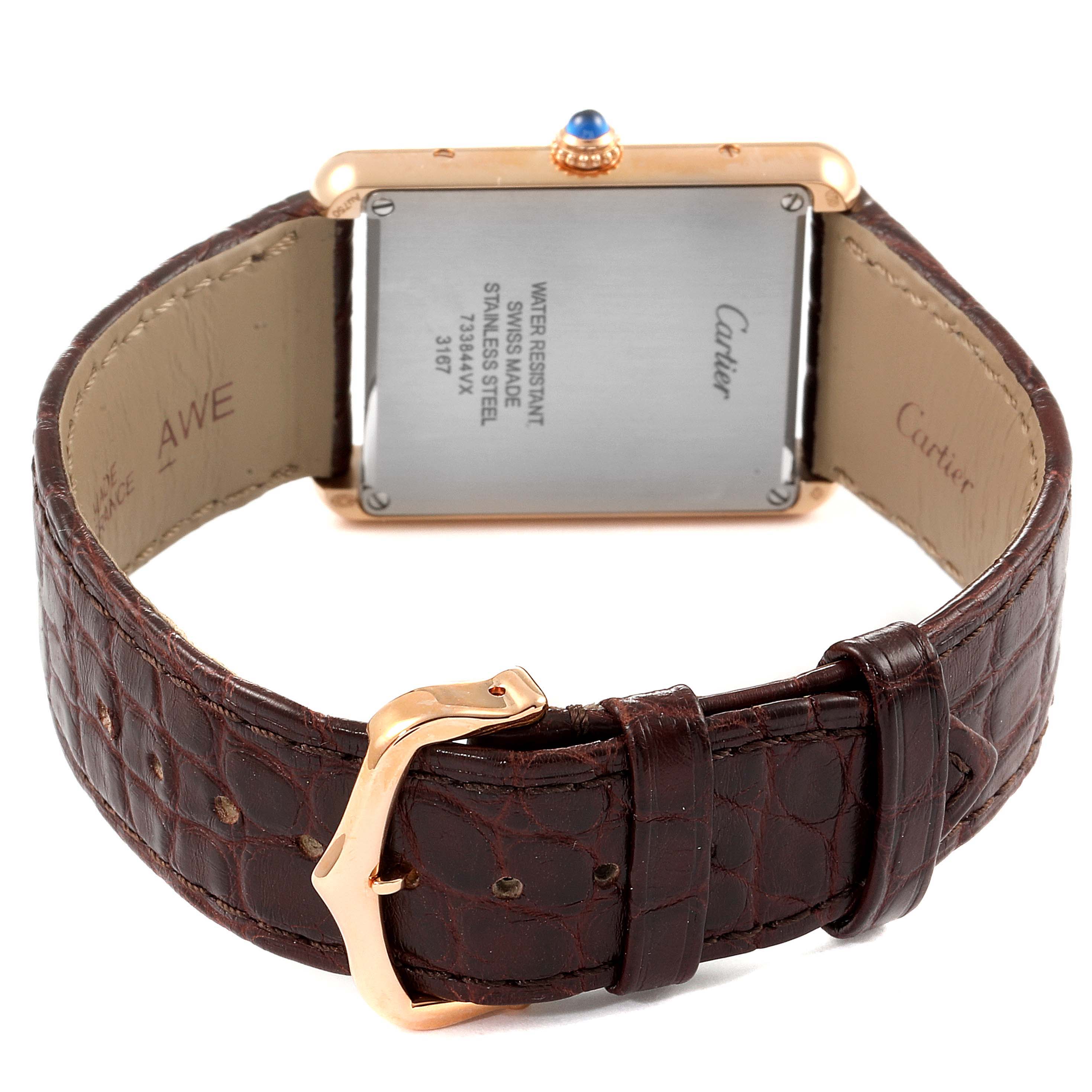 The Cartier Tank Solo W5200025 Men's Rose Gold Silver Dial W5200025 Men's Rose Gold Silver Dial watch is shown from the back, displaying its leather strap, buckle, and case back.