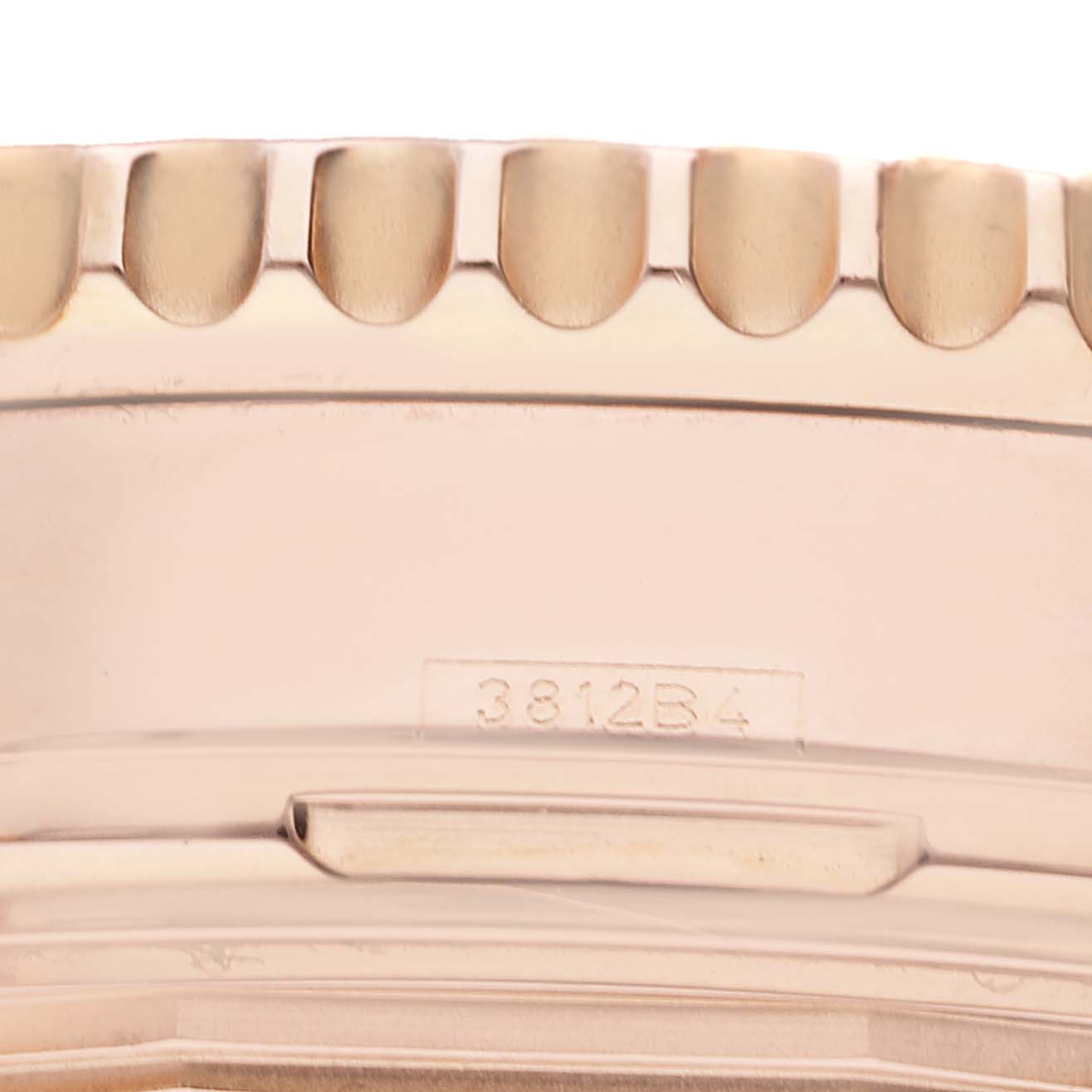 The image shows a close-up of the bezel and case side of a Breitling Navitimer RB0120 Men's Rose Gold Black Dial RB0120 Men's Rose Gold Black Dial watch with a visible serial number, 3812B4.