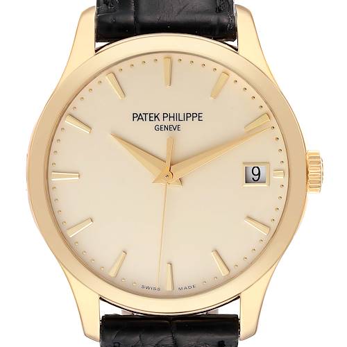 This image shows a front view of the Patek Philippe Calatrava 5227J-001 Men's Yellow Gold Beige Dial 5227J-001 Men's Yellow Gold Beige Dial watch, highlighting its dial, hands, date window, and leather strap.