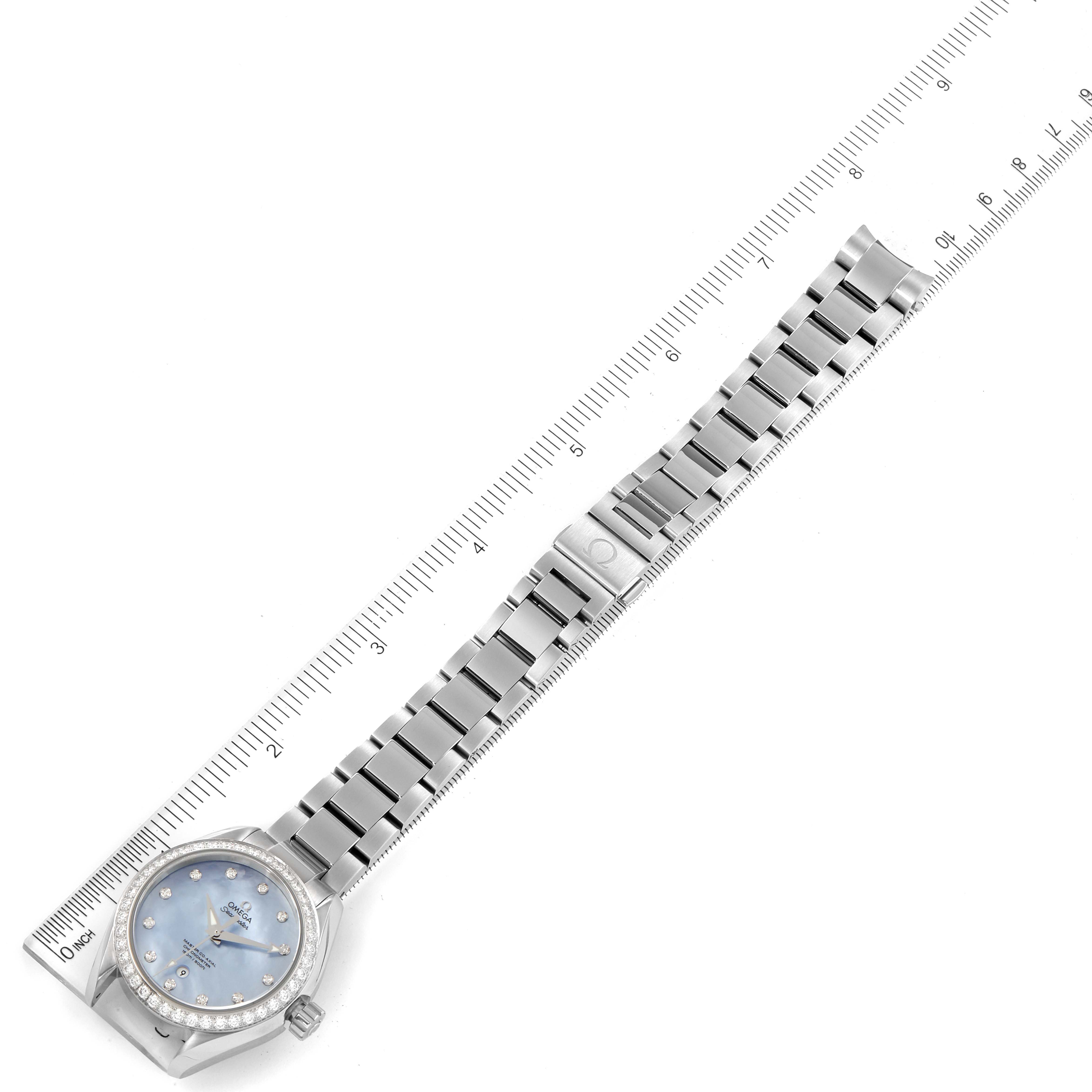The image shows an Omega 231.15.34.20.57.002 Women's Stainless Steel Mother of Pearl Dial 231.15.34.20.57.002 Women's Stainless Steel Mother of Pearl Dial Seamaster Aqua Terra MOP Diamond Steel Ladies Watch 231.15.34.20.57.002 laid flat with a ruler.