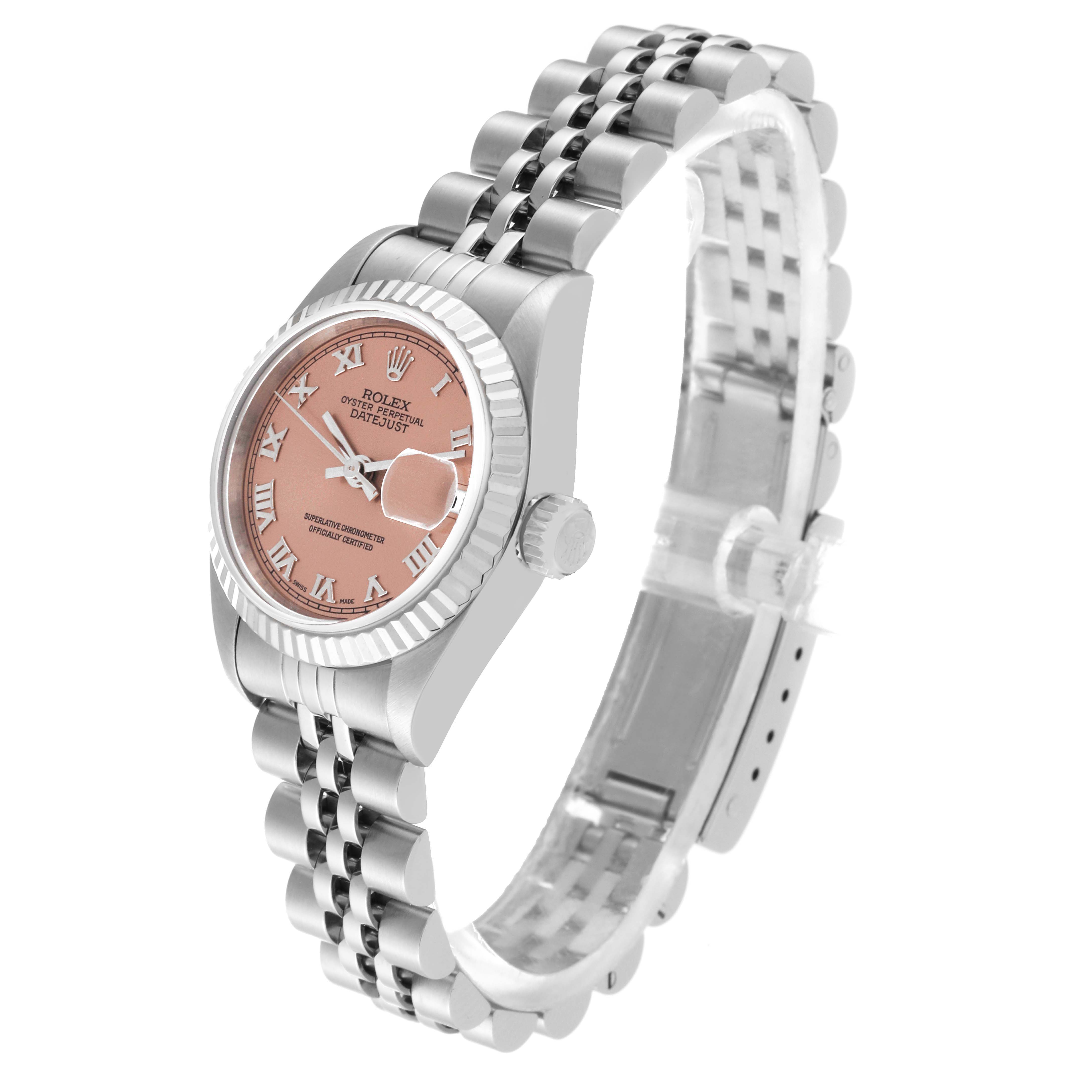 The image shows a Rolex Datejust 79174 Women's Stainless Steel Pink Dial 79174 Women's Stainless Steel Pink Dial watch at a slight angle, highlighting its pink dial, Roman numerals, fluted bezel, and stainless steel Jubilee bracelet.