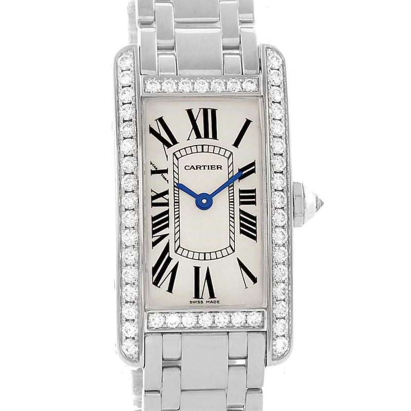 The image shows a front view of the Cartier Tank Americaine WB7073L1 Women's White Gold Silver Dial WB7073L1 Women's White Gold Silver Dial watch, highlighting its face, bezel with diamonds, and part of its bracelet.